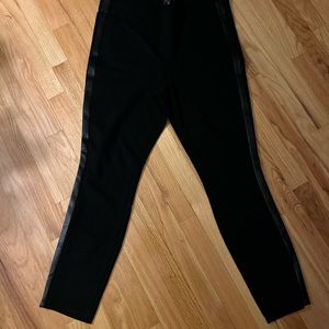 NYDJ black stretch fabric outer side  of legs are trimmed with faux leather